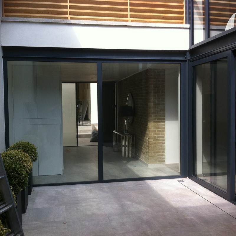 Floor-to-ceiling sliding doors opening to courtyard in Neasden