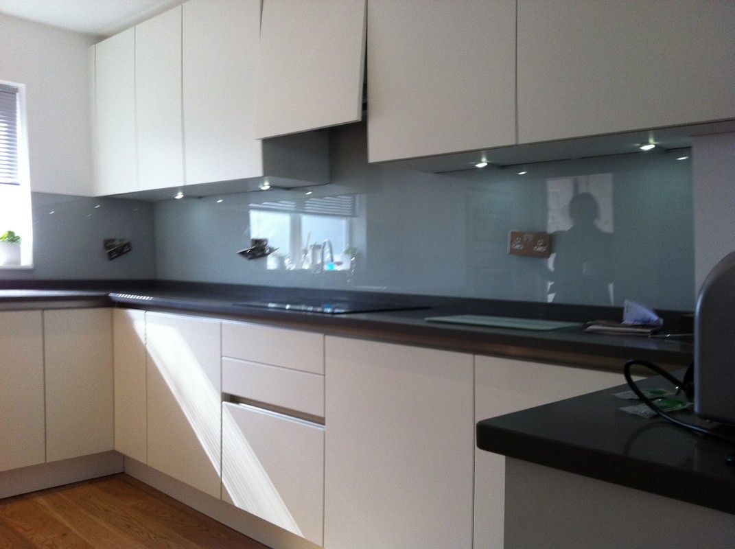 Grey glass kitchen splashback with LED lighting in Neasden
