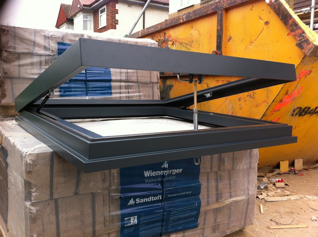 Opening flat roof skylight in anthracite grey installed in Neasden